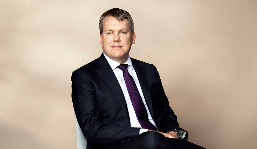 Stefan Widing, President and CEO, sitting on a chair. (photo)