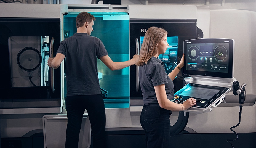 Two operators at a CNC machine (photo)